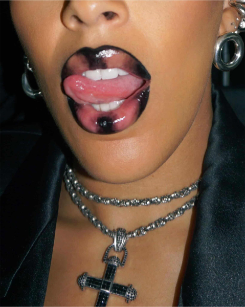 Closeup of Doja Cat with a black and nudetinted glossy fantasy lip combo.